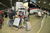 A mechanic works on Dave Darland's number 5 Toyota powered midget before the start of the final day of racing